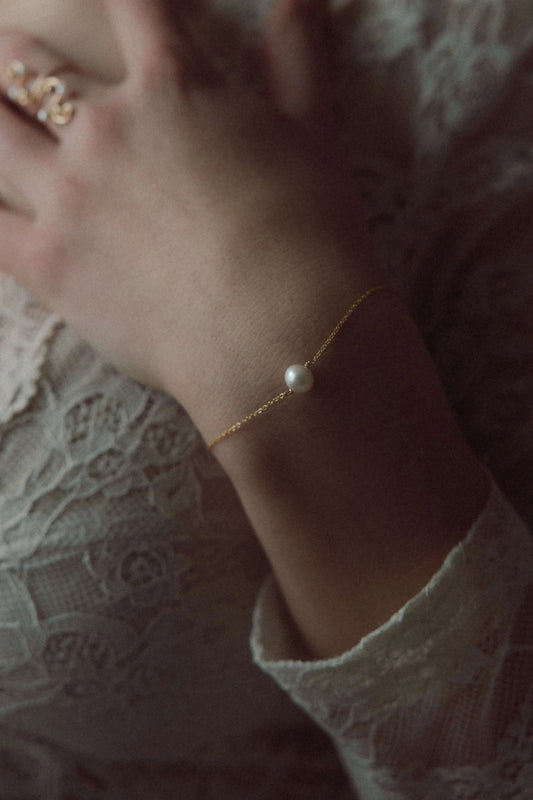 Bracelet élégant avec une perle d'eau douce blanche au centre